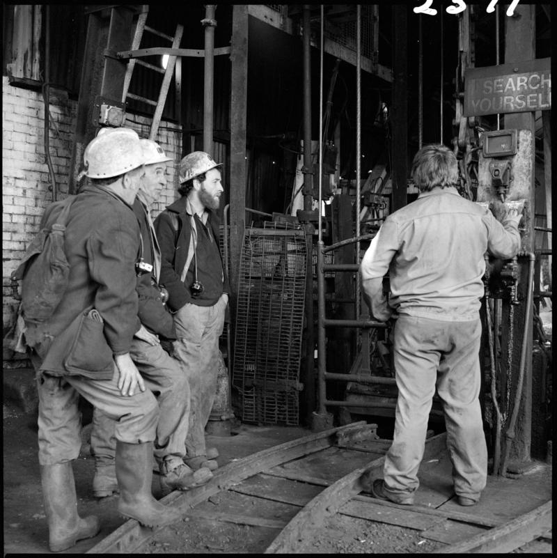 Black and white film negative showing miners waiting at pit top, Morlais Colliery 13 May 1981.  'Morlais 13/5/81' is transcribed from original negative bag.