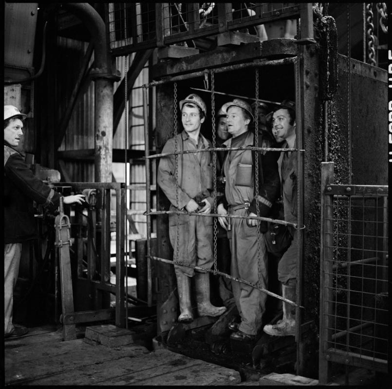 Black and white film negative showing men in the cage at pit top, Coegnant Colliery 25 November 1981.  'Coegnant 25 Nov 1981' is transcribed from original negative bag.