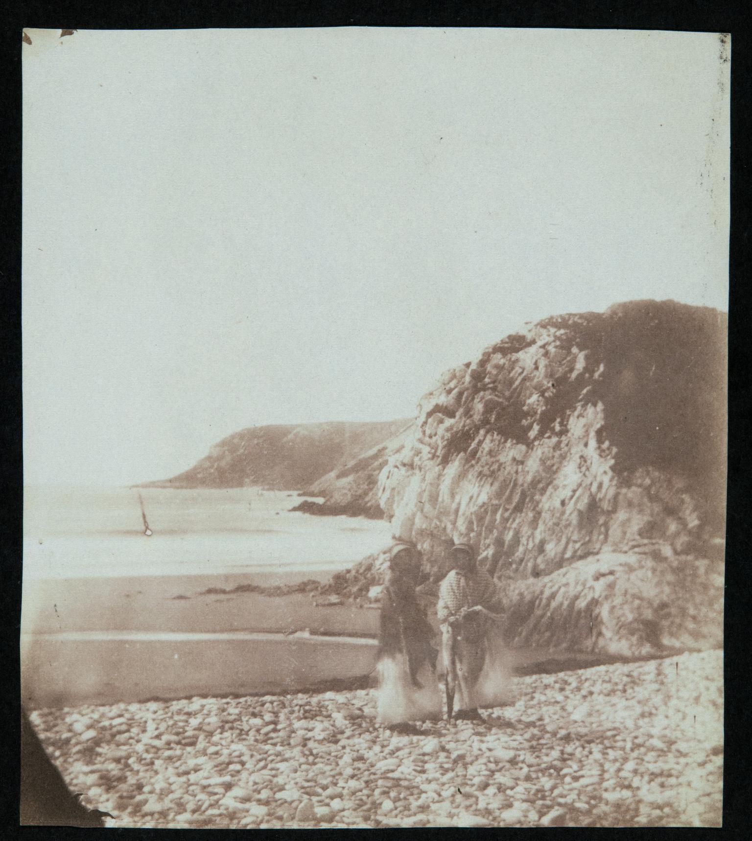 Two ladies on seashore, photograph