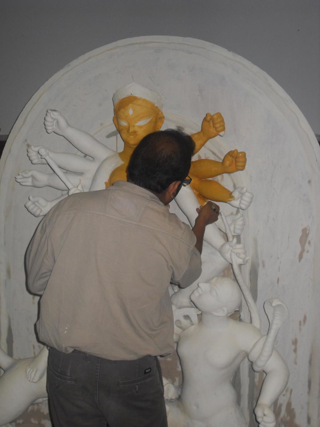 The artist Dibyendu Dey painting the Goddess Durga